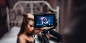 pressing record on woman in black lingerie in bed