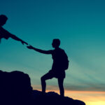 Enlisting help from others climbing a mountain