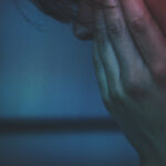 man staring at his phone scrolling through social media