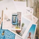 pile of polaroid photos on desk with pineapples