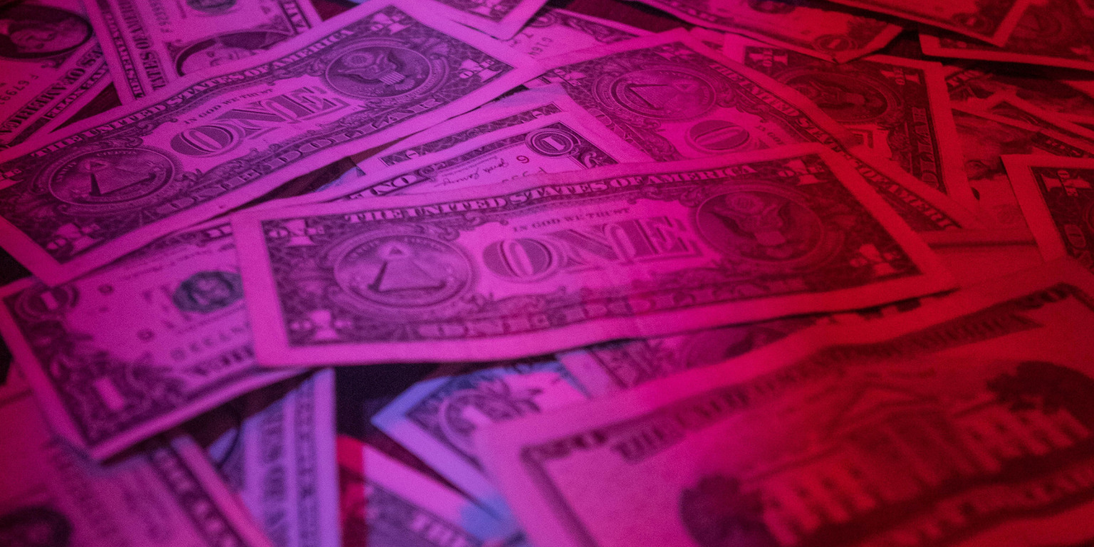 pile of USA one dollar bills surplus