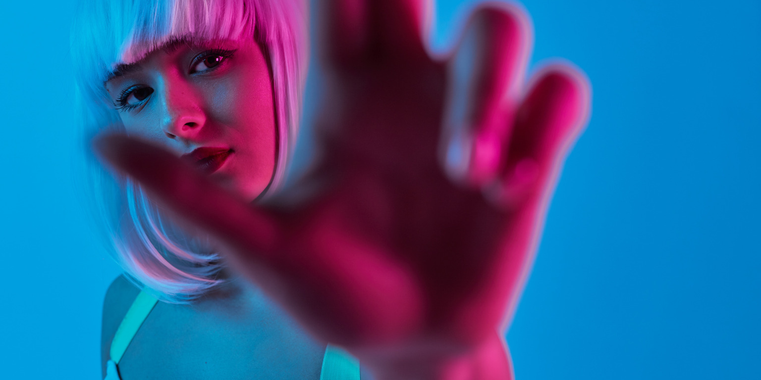 woman wearing white wig in blue and pink lighting