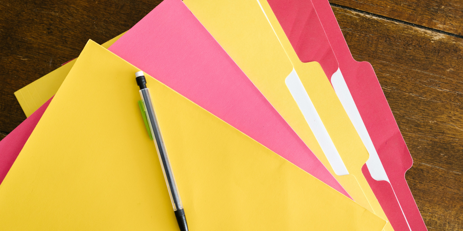 pile of folders spread across desk to sort niches