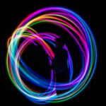 person in dark room making lighting swirls