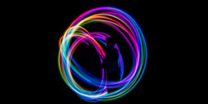 person in dark room making lighting swirls