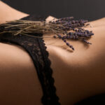 woman in black lingerie with flowers over pelvic region