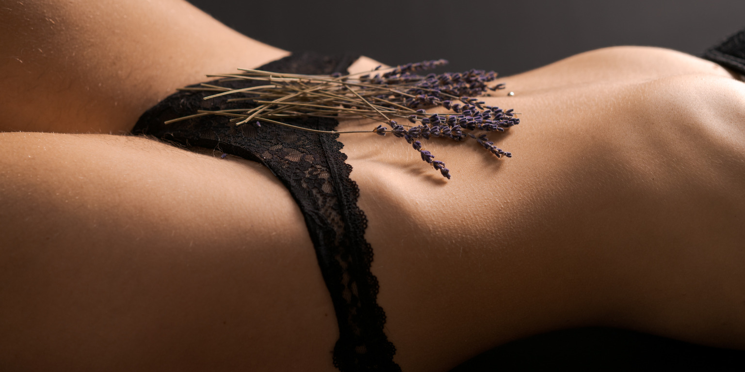 woman in black lingerie with flowers over pelvic region