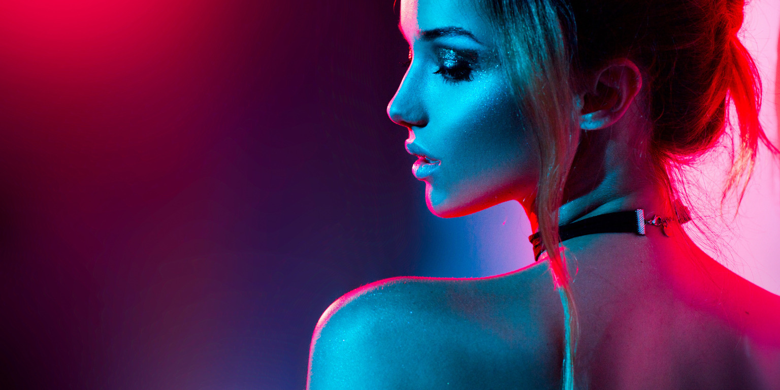 woman in mood lighting covered in glitter