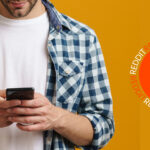 man on phone next to reddit logo