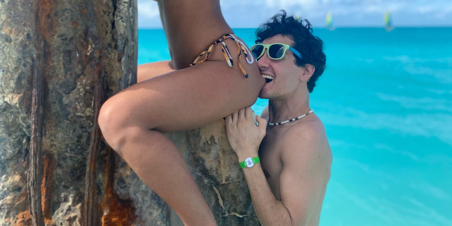 Man biting a woman's glute