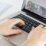 Man typing on Macbook