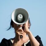 Woman speaking through a megaphone