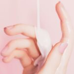 Milki falling on a hand with pink background